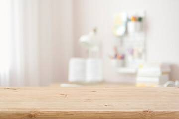 Wooden table top with blurred modern student room background