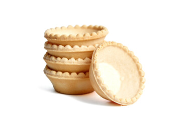 Tartlet shells isolated on white background. Stacked empty mini tart shells for portable desserts