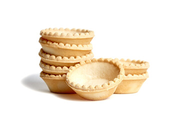 Tartlet shells isolated on white background. Stacked empty mini tart shells for portable desserts