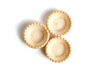 Tartlet shells isolated on white background, top view. Three empty mini tart shells for portable desserts