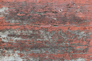 Old scratched wood abstract background - old red color painted weathered wooden plank