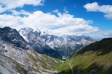 Fototapeta na wymiar View from the Stelvio Pass, the highest automobile pass in Italy, located between Trentino-Alto Adige and Lombardy, Italy. Ecologia and photo tourism concept.