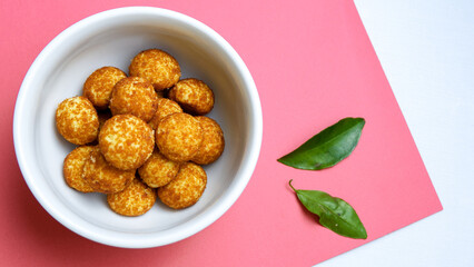 Palm sugar cookies on a white bowl, in bright mood. Round cookies coating with palm sugar.