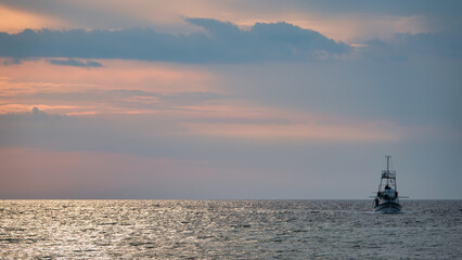 Fototapeta premium Fishing Trawler in Gokceada sea at sunset. Canakkale, Turkey