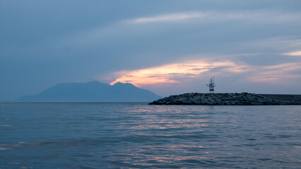 Sunset, Greek island Samothrace and lighthouse view at Gokceada Kalekoy location. Imbros island Canakkale, Turkey