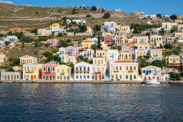 A Beautiful View, Framed by a Tree, of the Colorful Neo-Classical Houses in the Harbor of Symi, Greece