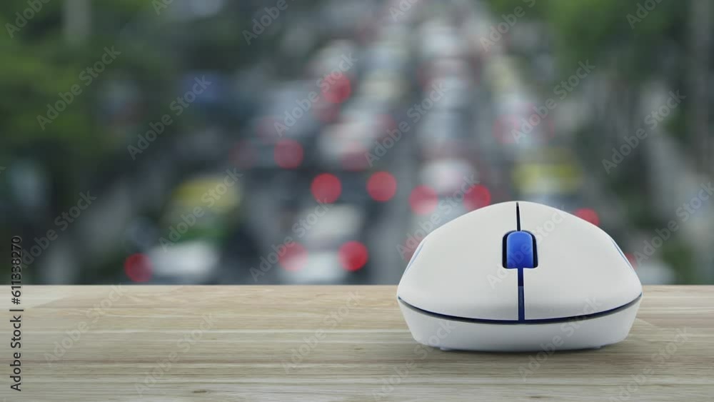 Poster cross shape with shield flat icon with wireless computer mouse on wooden table over blur of rush hou