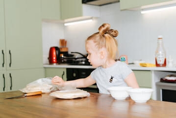 Fototapeta na wymiar Cute little girl cooking in the kitchen