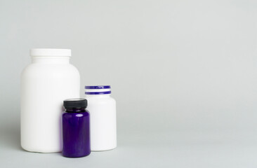 Plastic bottles for vitamins on color background