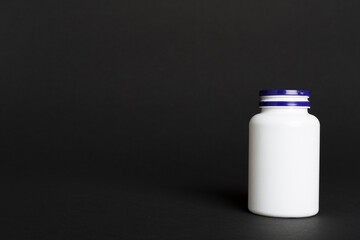 Plastic bottle for vitamins on color background