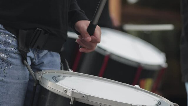 People hitting the drums on the street