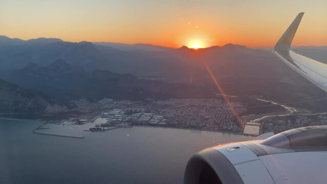 Sunset and small seaside town from the porthole