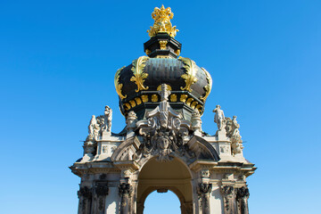 Tower with columns, decorative elements, sculptures and crown with golden elements. Sunny day with blue sky. Baroque style. Dresden, Art Gallery, Germany, May 2023 