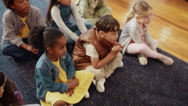 Learning the alphabet through song and rhyme: Primary school children engaging in a phonetics lesson in a classroom