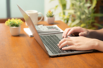 The busy businessman efficiently manages his work by skillfully utilizing his laptop, mobile phone, and calculator, seamlessly transitioning between devices to handle tasks and crunch numbers,close up