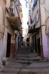 Naklejka premium Algiers (Alger), Algeria : Street scene in the Casbah. Stone stairs and ancient ottoman houses. Chiaroscuro atmosphere. 