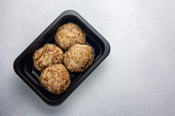 Delicious meat dishes in a black box. Delivery