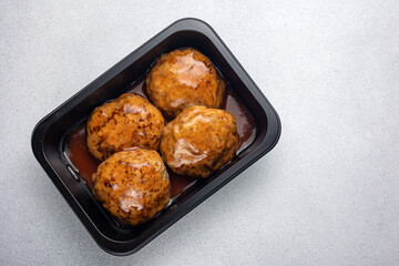 Delicious meat dishes in a black box. Delivery