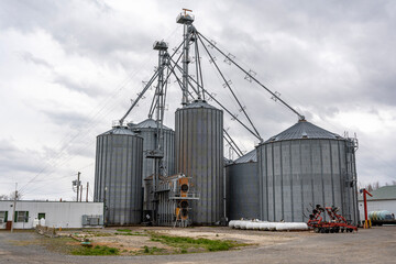 Fototapeta na wymiar Large, tall metal silver tower storage silos