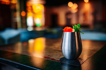 alcoholic cocktail in a glass stands on a table in a bar or restaurant