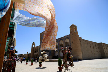 Silk drapes blowing in the wind in the historic center of Bukhara, Uzbekistan