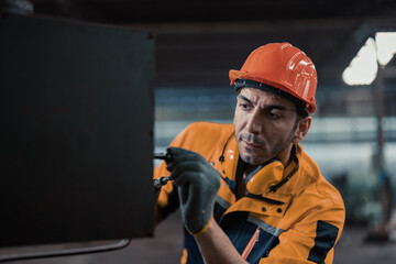 Skilled mechanical technicians tighten, loosen components with screwdriver to perform safety...