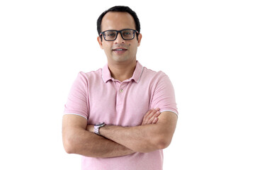 Portrait of a middle aged happy smiling Indian man in a pink T-shirt wearing glasses, standing with...