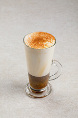 Glass mug of sweet coffee con pana with cream