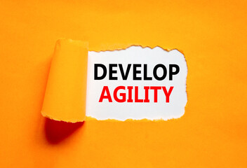 Develop agility symbol. Concept words Develop agility on beautiful white paper on a beautiful orange background. Business, support and develop agility concept. Copy space.