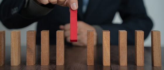 insurance with hands protect domino. Businessman hands stop dominoes falling in business crisis....