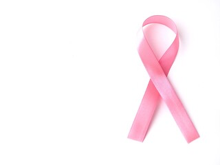 Pink breast cancer awareness ribbon on a white background with copy space 
