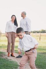 Fototapeta premium A happy family spending time together in a field.