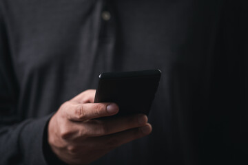 man hand holding and using smartphone, tablet, cell phone touching on screen. mobile phone application technology. copy space for text.