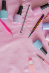 detailed view of various elements to perform talez manicure such as nail polishes, cuticle pushers,...