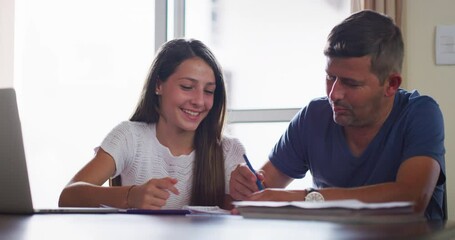 Laptop, dad and daughter with paperwork for homeschool at table with internet, writing notes and distance or e learning. Computer, father and teen working together on research for home school project
