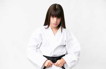 Little caucasian girl over isolated white background doing karate
