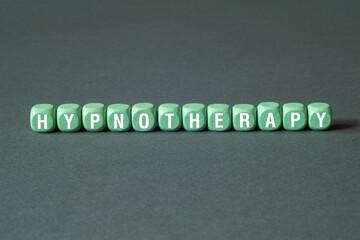 Hypnotherapy - word concept on building blocks, text