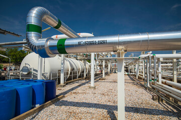 Oil barrels blue or chemical drums vertically stacked up ball valve at pipeline oil and gas wellhead