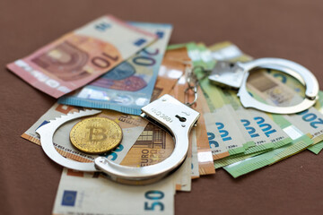 Turkish lira banknotes, US Dollars, Euro and bitcoin coin Euro handcuffs