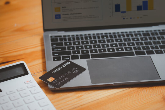 Close up image of Mockup credit card put on laptop cpomputer. Online shopping ,Cashless method pay bills in commercial spaces concept.