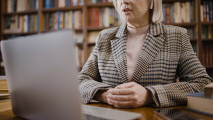 Experienced professor conducting an online lecture, distance education, via video call