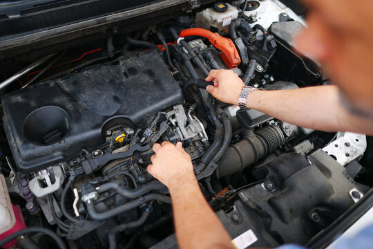 male mechanics hands check electrical wiring vehicle system in a car service
