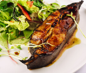 Pan fried salmon in teriyaki sauce on plate