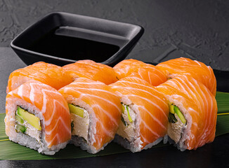 Set of salmon sushi rolls on stone board