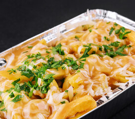 delicious french fries with cheese sauce
