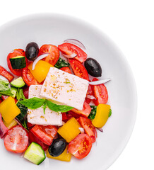 Greek salad of organic vegetables with tomatoes, cucumber, red onion, olives