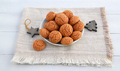 Traditional Italian almond cookies amaretti on a white background with copy space.Famous amarettini cookie biscuits.Delicious Christmas pastry popular in Italy.Selective focus.