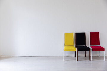 Chairs yellow red black in a bright room on a white background