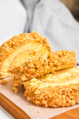 Three Slices of Peanut Roll Cake with Rhum on the Wood Board