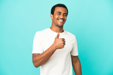 African American handsome man on isolated blue background giving a thumbs up gesture